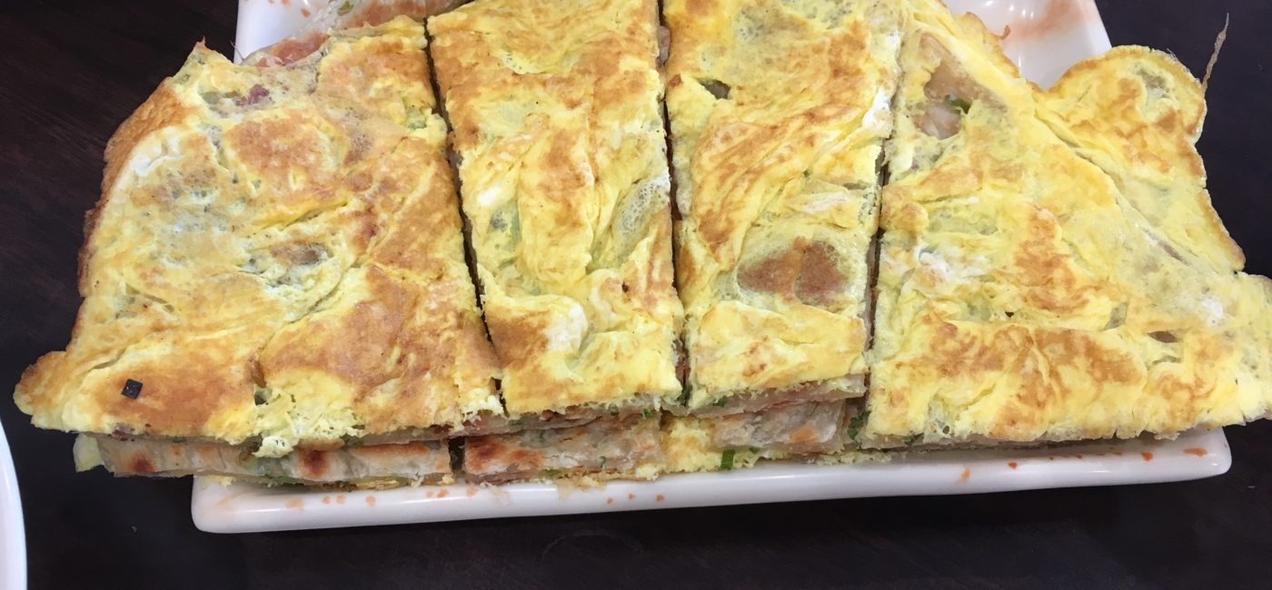 Green Onion Pancake with egg, served on an undersized white rectangular plate.