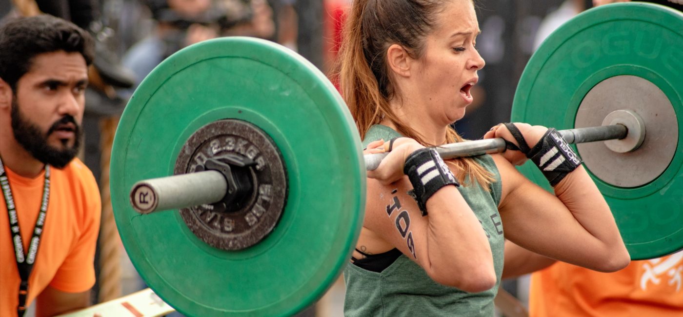 photo of a woman lifting a barbell