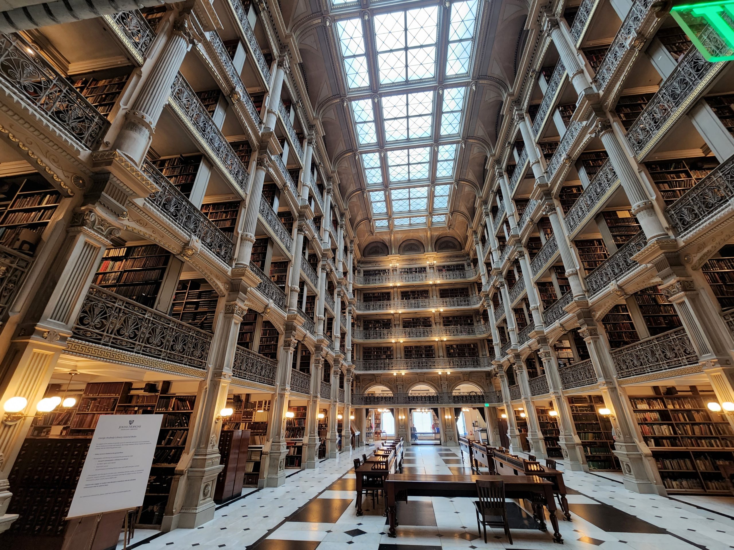 Interior of Peabody Library, showing the very ornate, aesthetic stacks and skylight.
